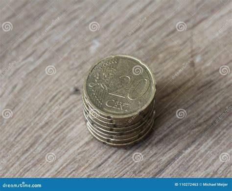 Stack Of Twenty Euro Cent Coins On Wooden Background Stock Image