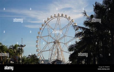 Ferris wheel in Manila, Mall of Asia. Ferris wheel against a blue sky ...