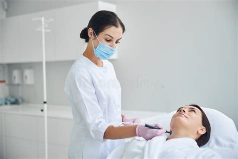 Doctor Cauterizing A Nevus Using Electric Current Stock Image Image