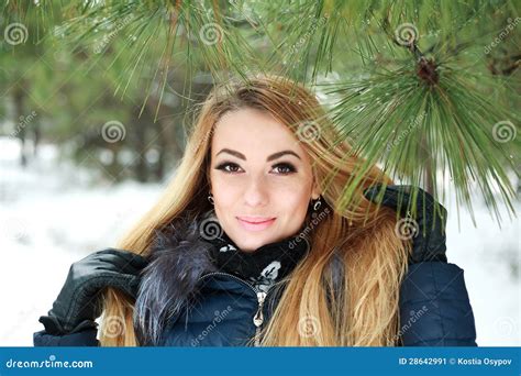 Close Up Portrait Of Beautiful Smiling Girl In Winter Pinewood Stock