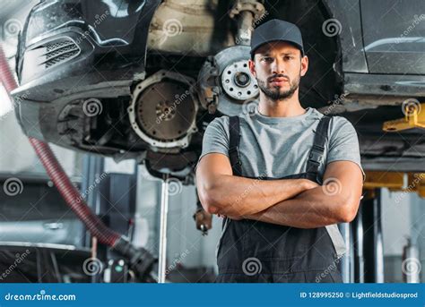 Confident Mechanic Posing With Crossed Arms In Auto Stock Photo Image