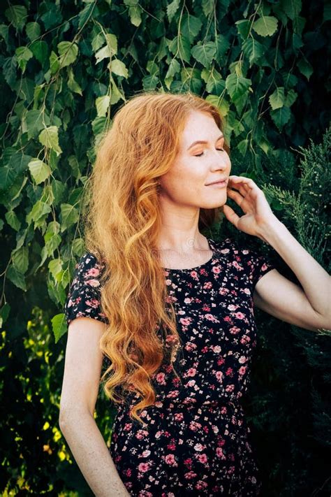 Portrait Of A Serious Beautiful Redhead Women Closed Eyes Touching Her