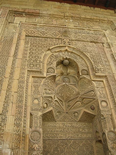 An Intricately Carved Doorway On The Side Of A Building