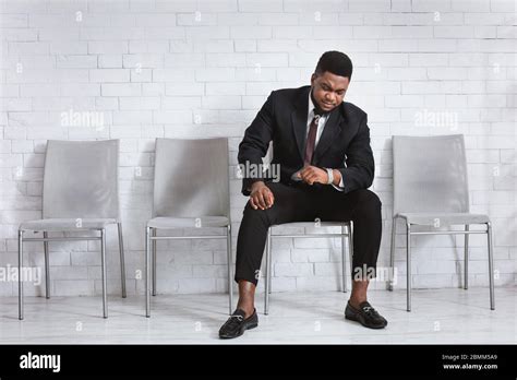 Millennial African American Guy Waiting For Job Interview Looking At