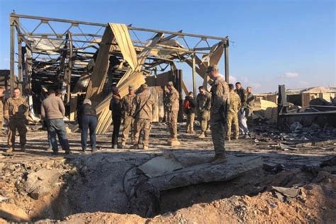 U.S. soldiers and journalists inspect the rubble at a site of Iranian ...