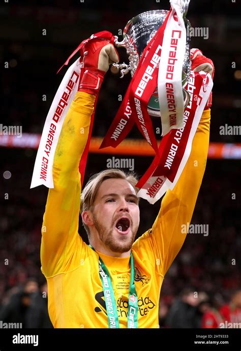 Liverpool goalkeeper Caoimhin Kelleher celebrates with the trophy after ...