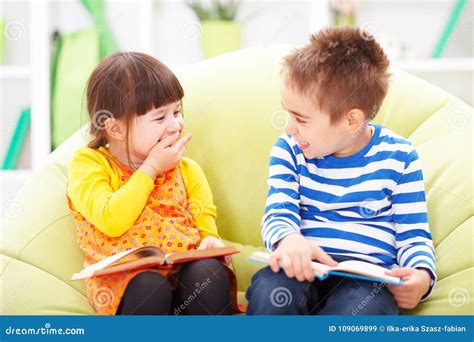 Little Girl And Boy Reading And Laughing Stock Image Image Of Read