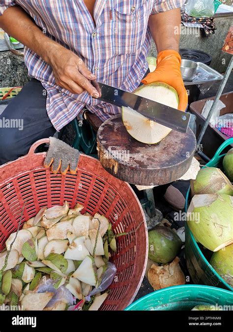 Hand Man Peeling Coconut With Knife Stock Photo Alamy