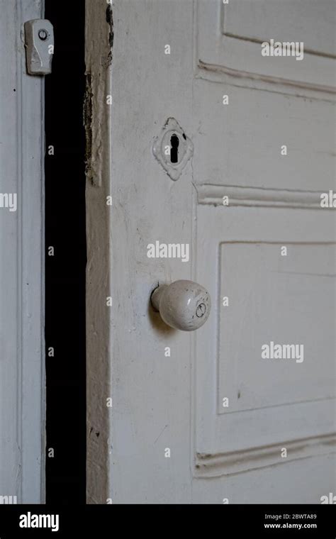 Close Up Of A White Painted Old Damaged Wooden Door Of An Empty