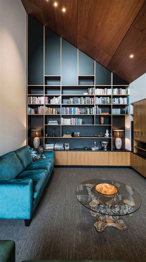 Contemporary Living Room With Blue Velvet Sofa And Black Accent Wall