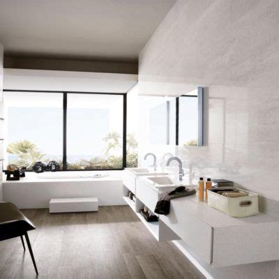 A Modern Bathroom With Large Windows And White Walls Along With Two