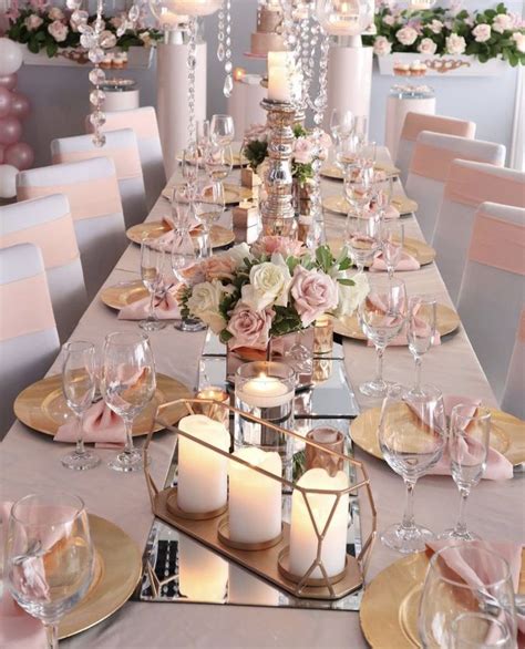 A Table Set With Candles Plates And Flowers For A Formal Dinner Or