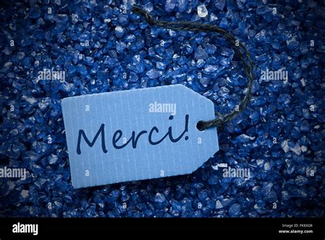 Purple Stones With Label Merci Means Thank You Stock Photo Alamy