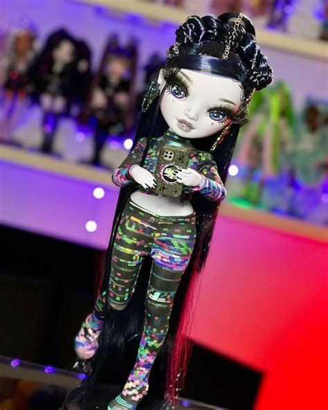 A Doll With Long Black Hair And Colorful Clothes On Display In A Store