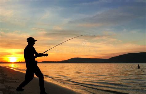 Young Man Fishing at Sunset Stock Image - Image of catch, landscape ...