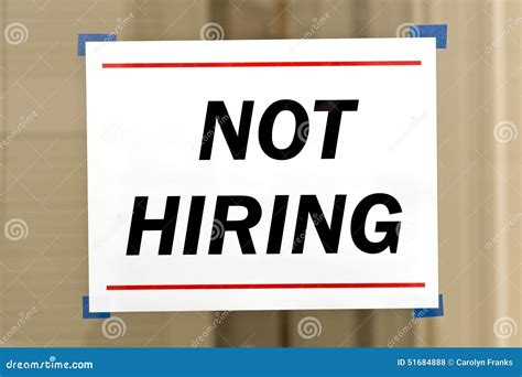 Now Hiring Sign On A Brick Building Stock Image