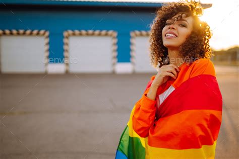 African American Lesbian Woman Holding Lgbt Rainbow Flag Concept