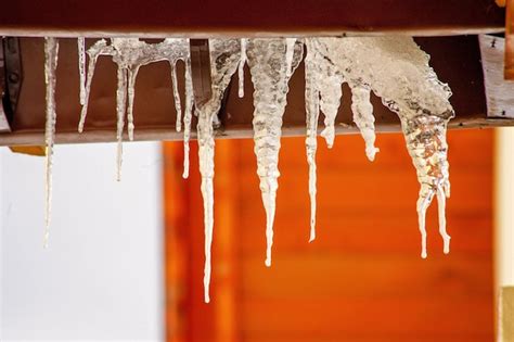 Premium Photo Close Up Of Icicles Hanging From Roof