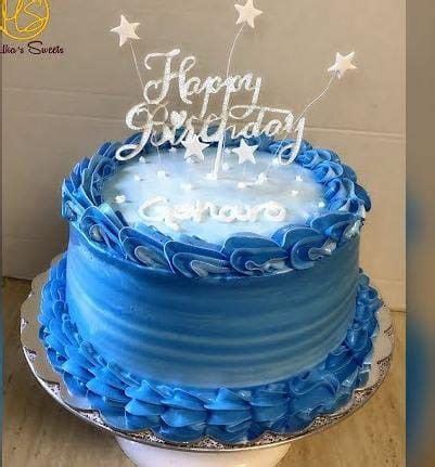 A Blue Birthday Cake Sitting On Top Of A Table