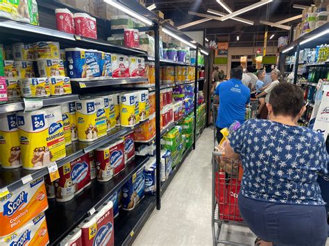 Storm shoppers face long lines, debit card and ATM outages - Cayman Compass