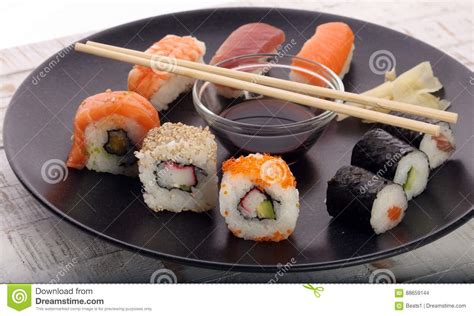 Close Up Of Sashimi Sushi Set With Chopsticks And Soy Sushi Roll With