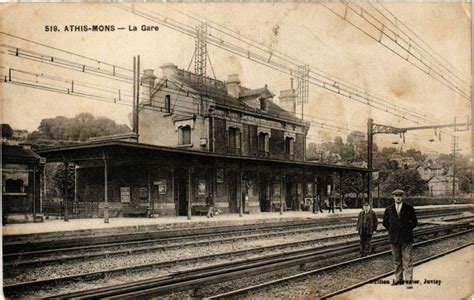 An Old Black And White Photo Of Two Men Walking On The Tracks In Front