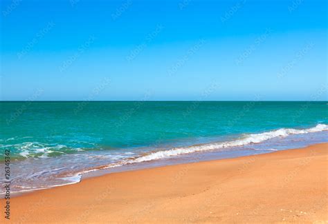 Sandy beach of seaside resort with clear water Stock Photo | Adobe Stock