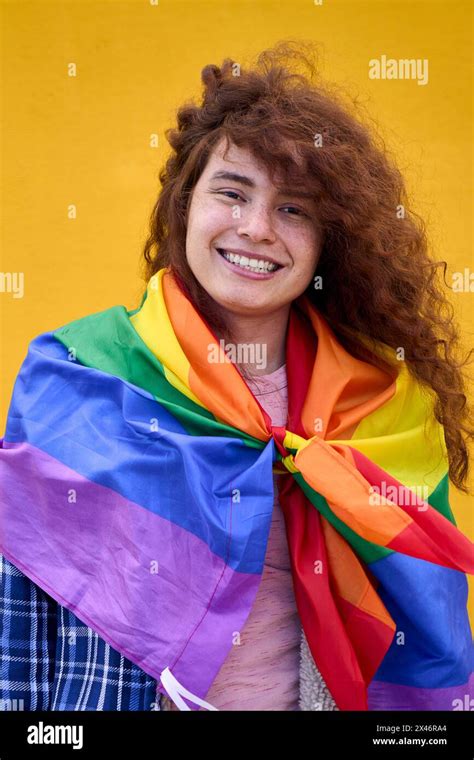 Portrait Of Cheerful Non Binary Person Red Hair With Rainbow Flag Over