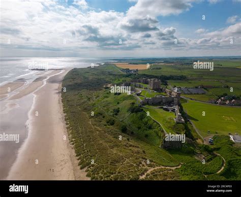 Aerial Drone Photo Of Bamburgh Castle At The Beautiful Coastline Of