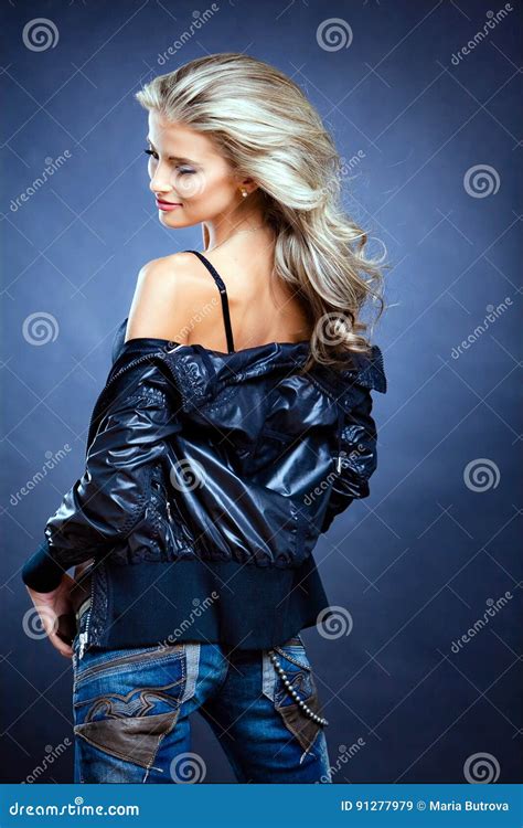 Beautiful Sensual Girl Blonde In A Leather Jacket On A Blue Stock Image