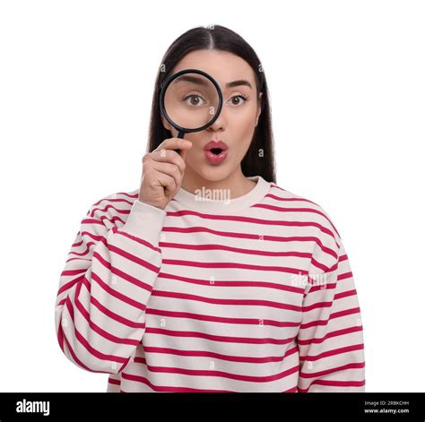 Curious Young Woman Looking Through Magnifier Glass On White Background