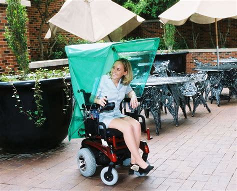 An Automatic Umbrella Or Rain Cover That Attaches To A Powered Wheelchair And Operates With Th