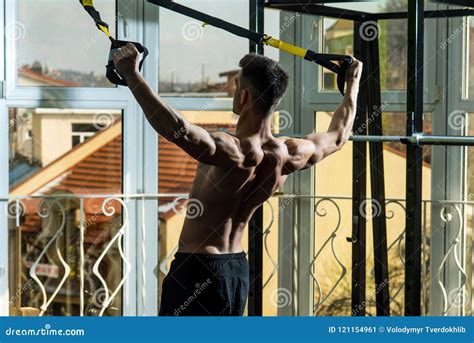 Sport And Gym Concept Man With Nude Torso And Muscular Back In Gym Enjoy Training Trx Stock