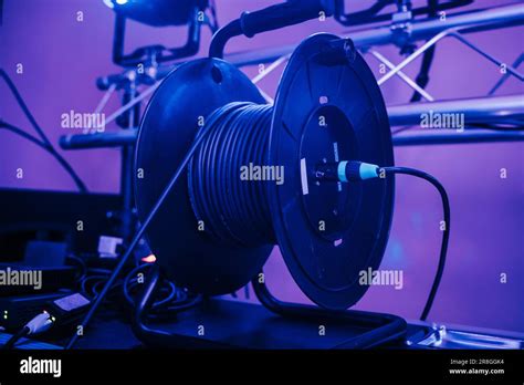 A Stage Cable Reel Is Situated On A Table Supporting A Large Audio