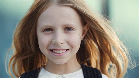 Portrait Little Happy Cute Blonde School Girl With Blue Eyes Looks Friendly At Camera Smiling