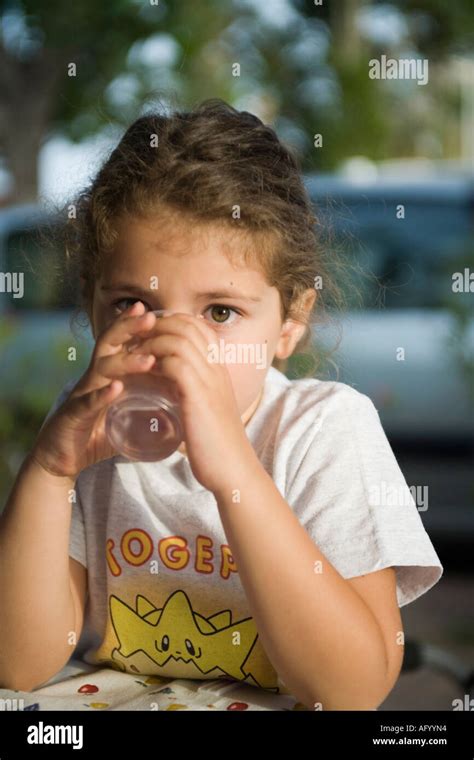 Thirsty Little Girl Drinking A Glass Of Water Stock Photo Alamy