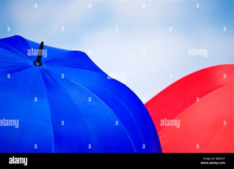 A blue and a red umbrella against the sky Stock Photo - Alamy