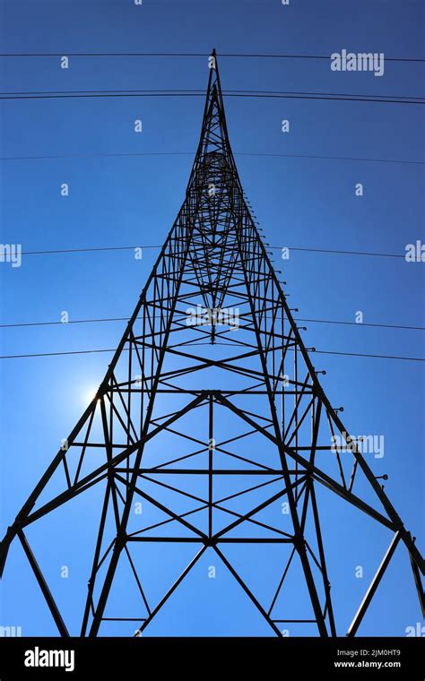 A Low Angle View Of High Voltage Power Transmission Towers In The Sky