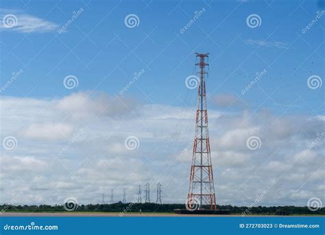 A Row Of Red And White Electricity Transmission Towers Over The Amazon