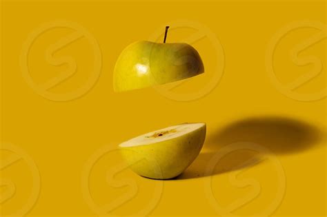 Apple Sliced On Half With One Half Floating Creative Fruit Concept By