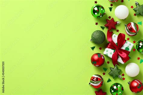 Red and green Christmas decorations on light green background. Christmas frame. Flat lay, top ...