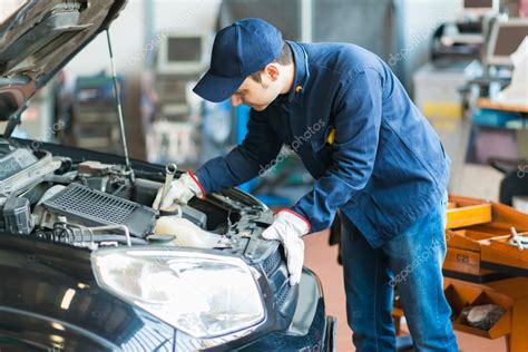 Mechanic At Work On Car In Garage Stock Photo Minervastock 67067531