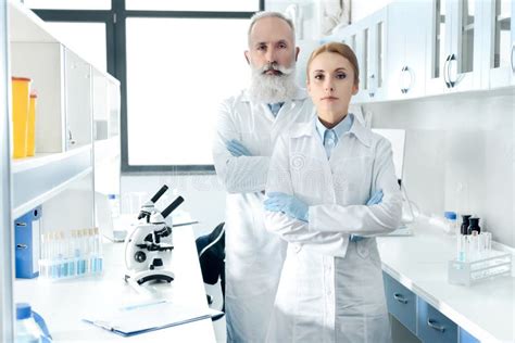 Scientists In White Coats Medical Gloves And Goggles Making Scientific