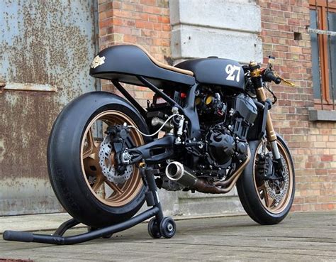 A Black Motorcycle Parked Next To A Brick Building