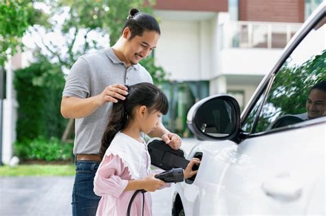 Premium Photo Progressive Concept Of Father And Daughter With Ev Car