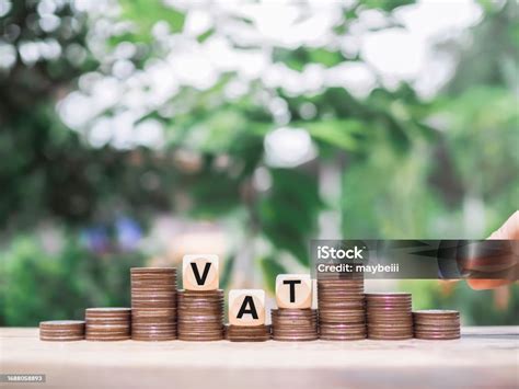 Close Up Hand Putting Coin In Stack Of Coins Wooden Blocks With The