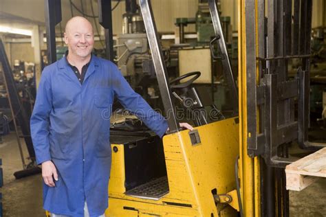 Warehouse Worker Standing By Forklift Stock Photo Image Of Camera