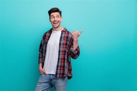 Photo Of Excited Funky Man Dressed Plaid Shirt Looking Pointing Thumb Empty Space Isolated