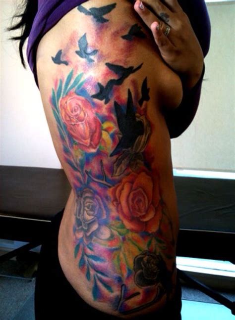 A Woman S Stomach With Birds And Roses On Her Side In Front Of A Mirror