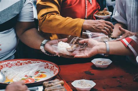 Homeless And Needy People Receive Help Receive Food From Volunteers